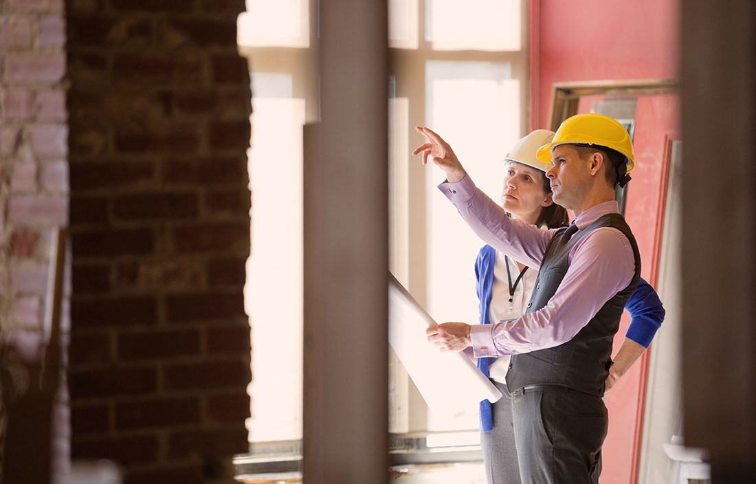 Image of architects - a man and a woman - discussing interior facility improvements