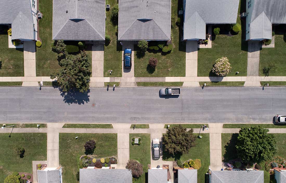 Aerial view of rows of senior living homes along a paved street