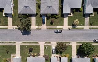 Aerial view of rows of senior living homes along a paved street
