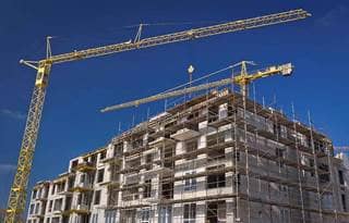 Construction of an apartment with cranes
