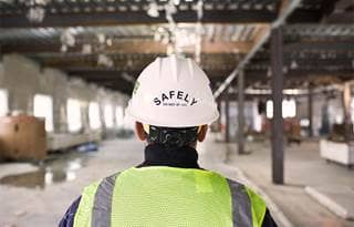 Image of the back of a person with a saftey helmet on