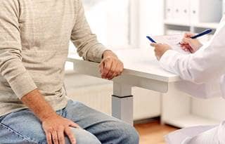 Image of doctor and senior in doctor's office