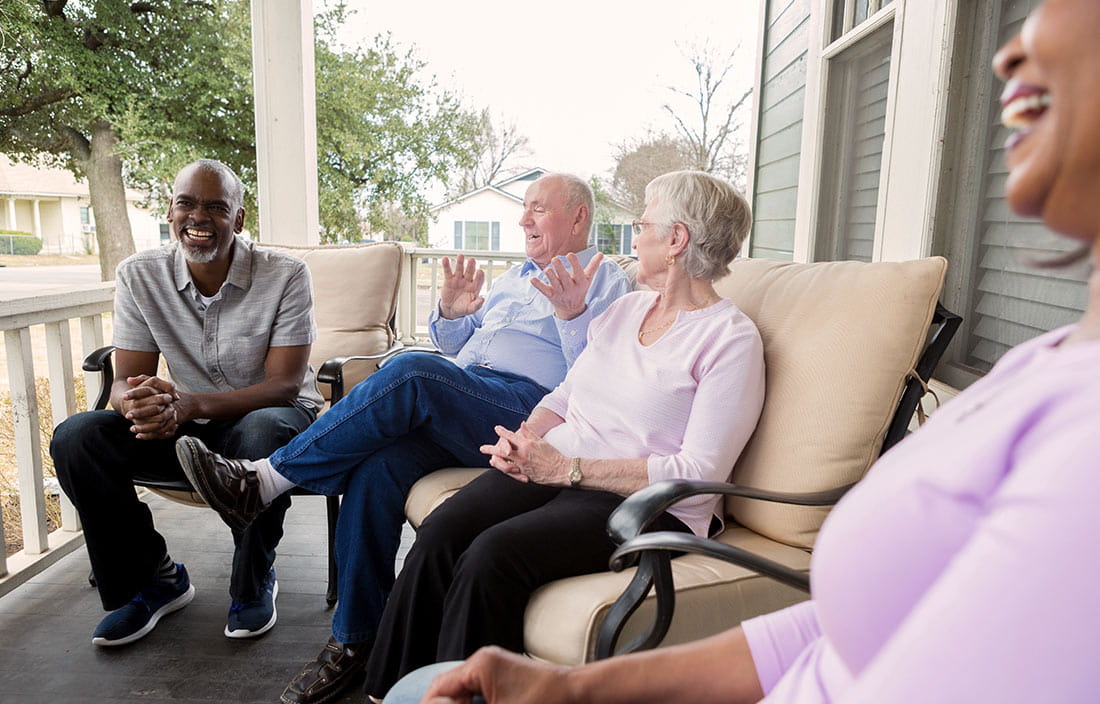 Diverse group of seniors enjoying time together at their home in a senior living community