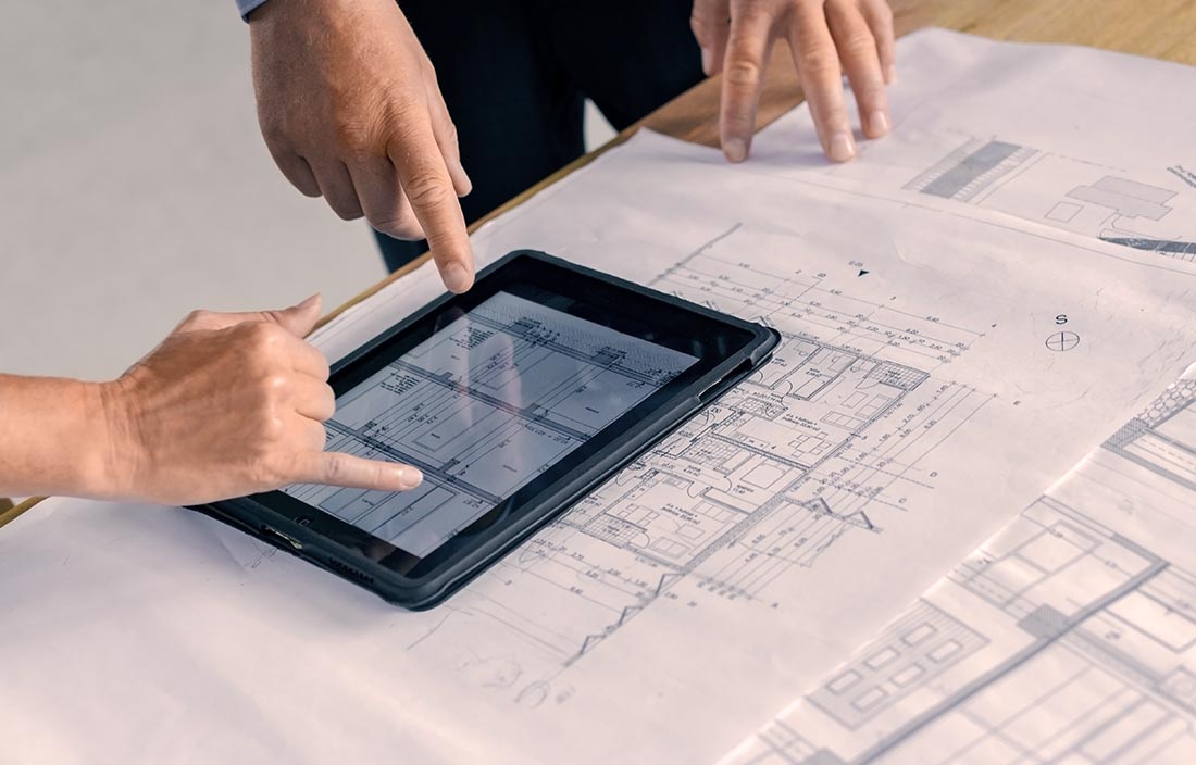 Senior living architects change design plans on a tablet for senior living residence due to COVID-19