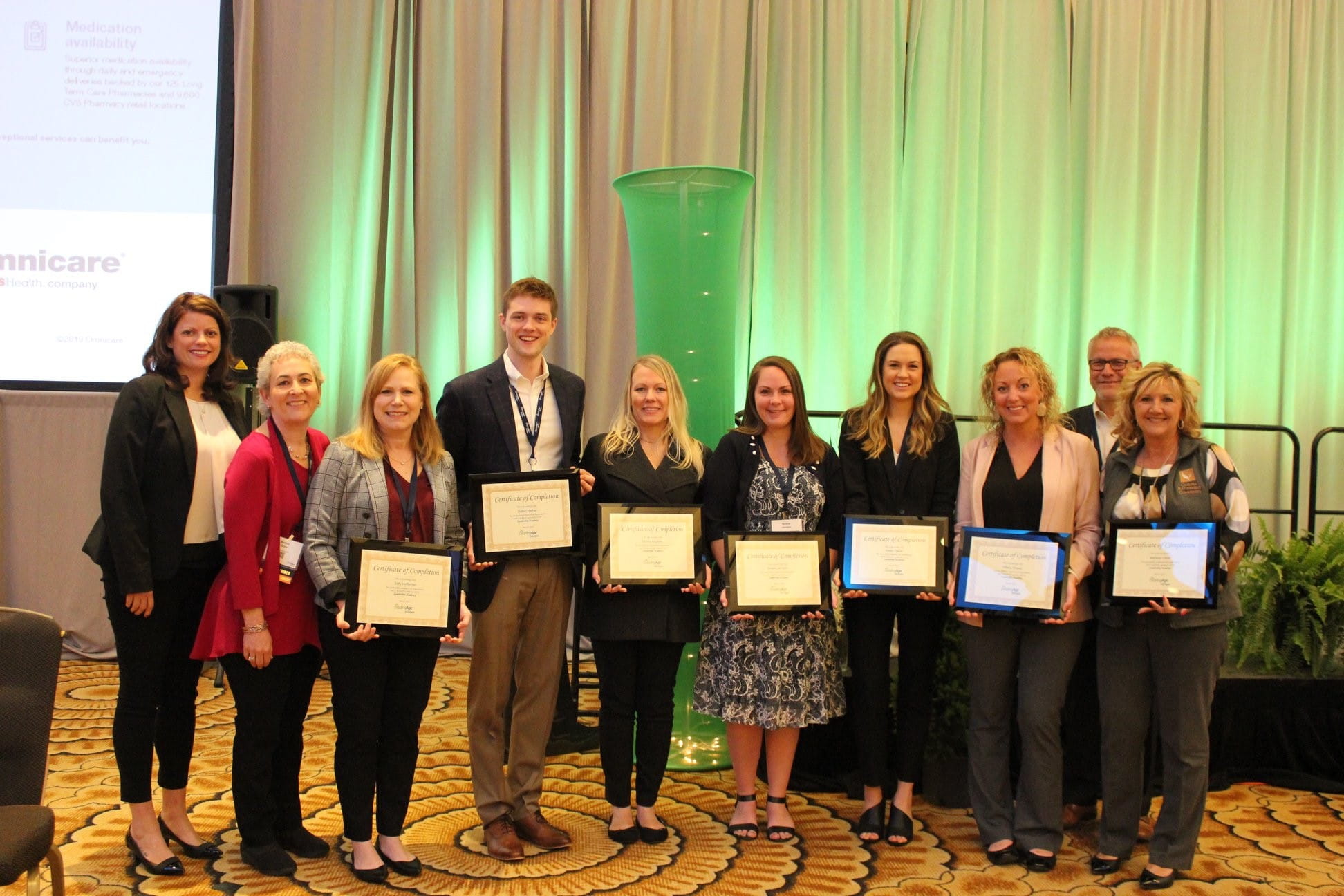 Sally Heffernan and members of the 2019 LeadingAge Michigan Leadership Academy program showing off their certificates