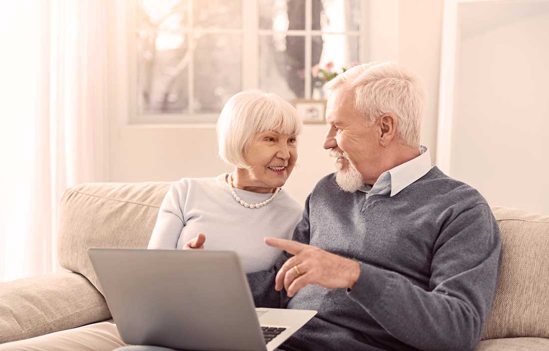 Senior couple looking online for senior housing options during COVID-19