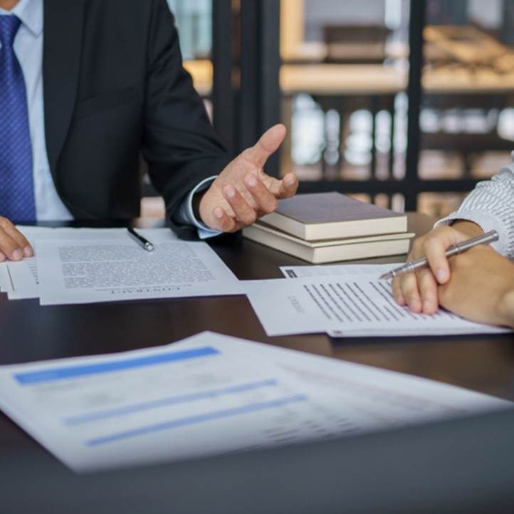 Business professionals reviewing a contract.