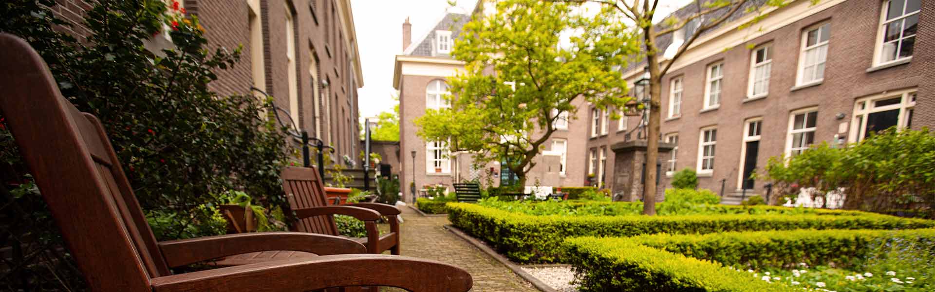 Exterior grounds of religious congregation's home, with close-up of bench and residences