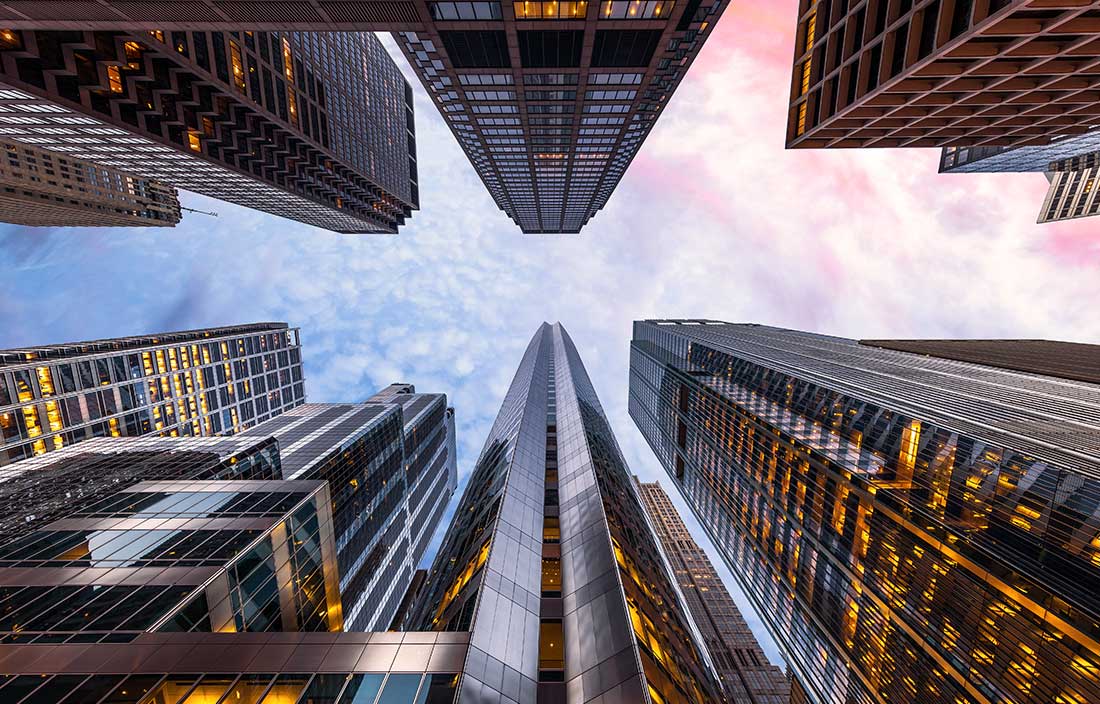 Photo of skyscrapers from vantage point of the ground looking up to the sky