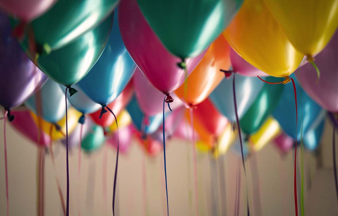 Image of colorful balloons groups together for a celebration of a promotion or new hire
