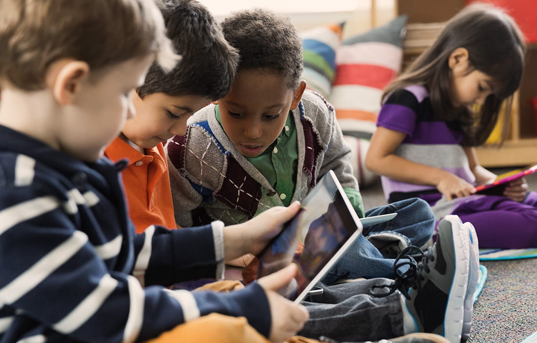 Image of kids playing on tablet