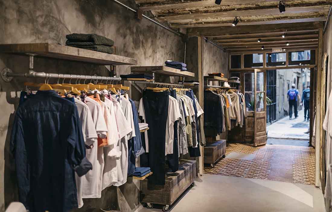 Clothing hanging on racks in empty store