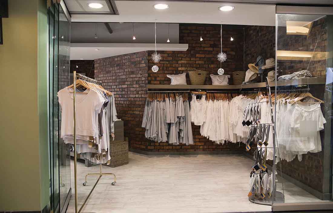 Empty store front with clothes on racks