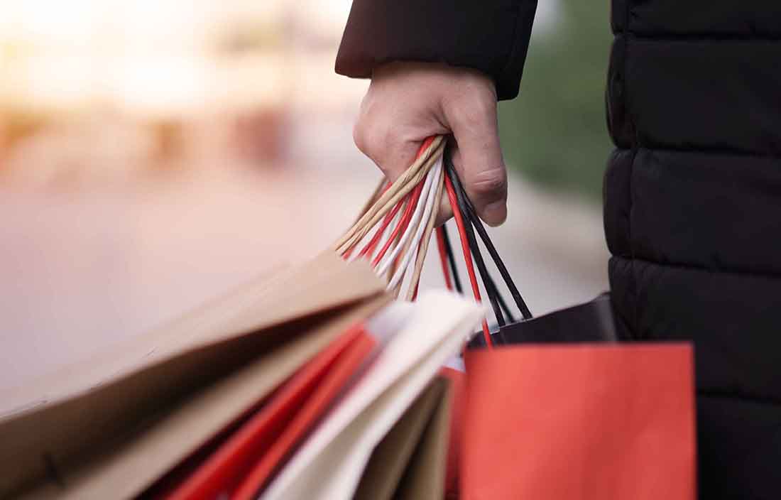 Hand holding shopping bags