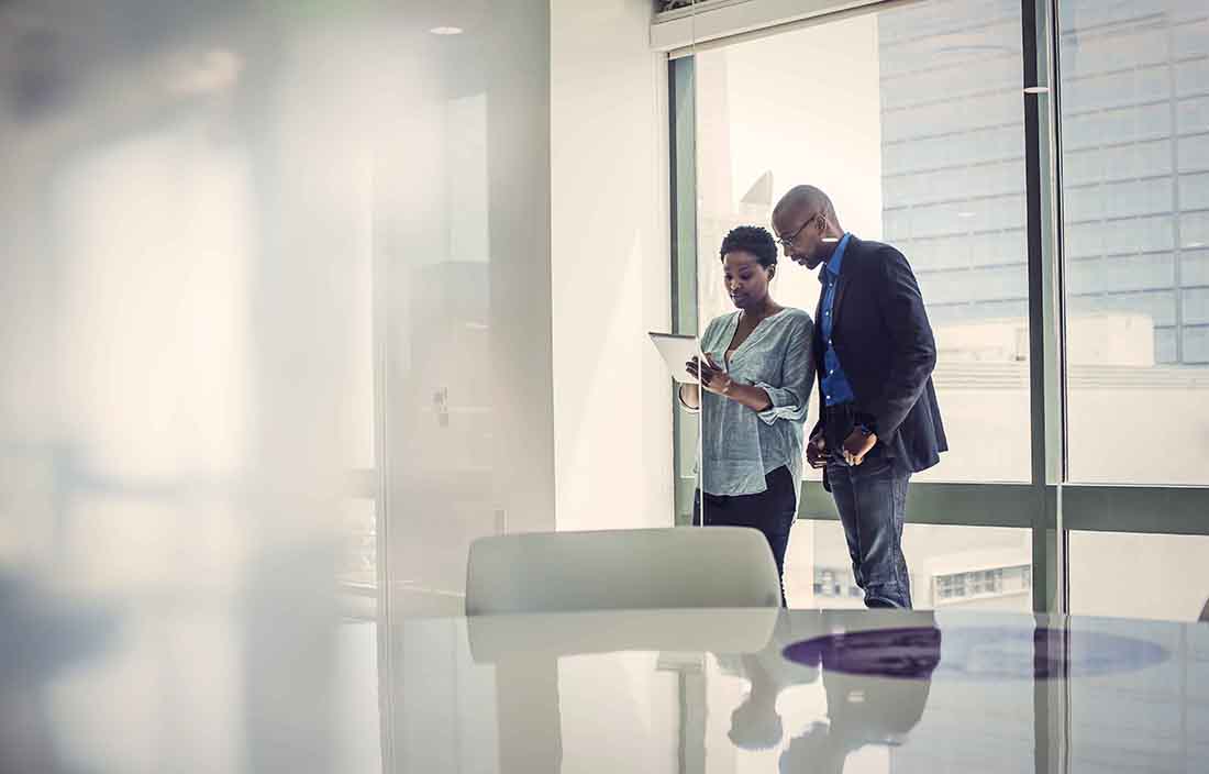 People standing looking at tablet