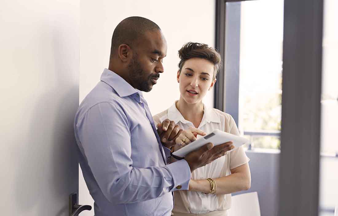 Two people looking at a tablet reviewing consumer price index data