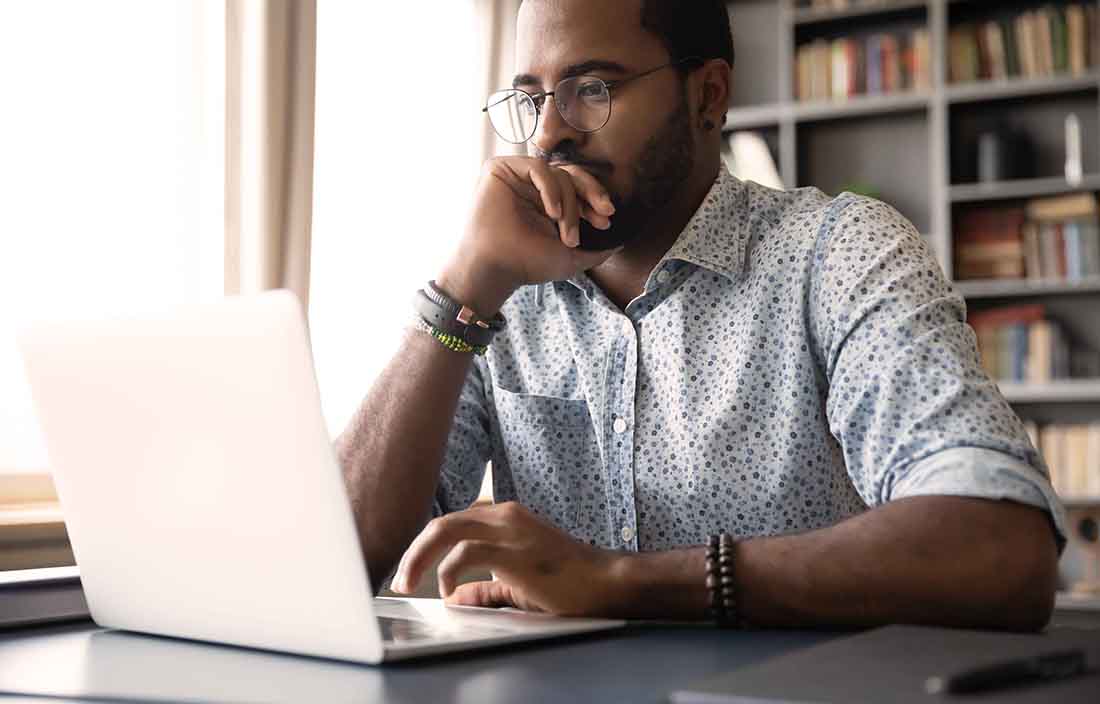 Man looking at computer thinking