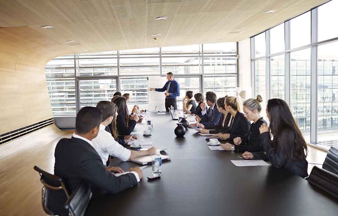 People in a conference room discussing labor markets