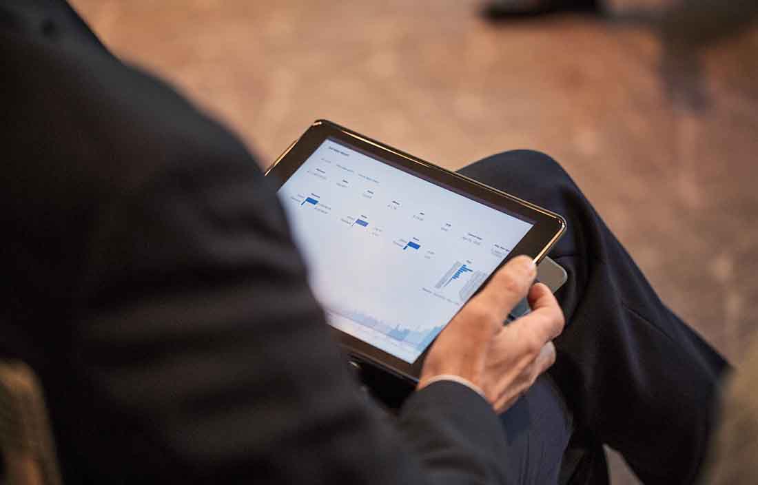 Person holding tablet reviewing financial information