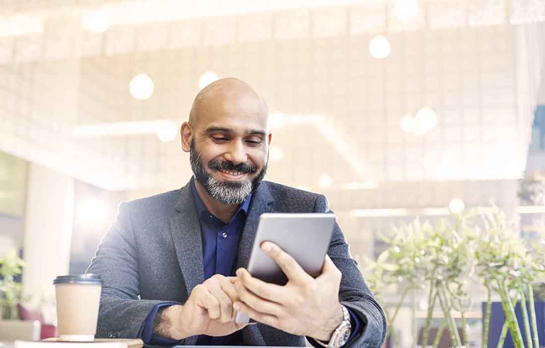 Man holding tablet smiling