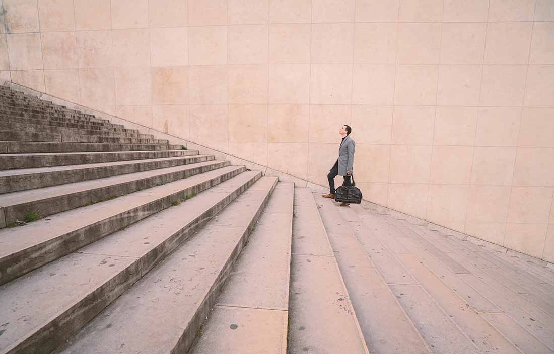 Man walking up outdoor building steps