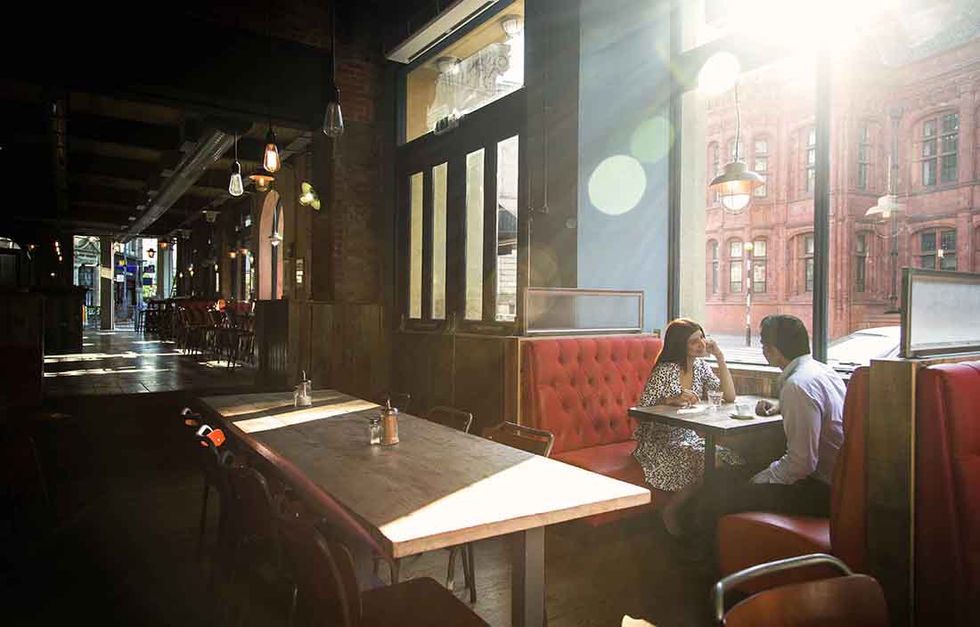 Two people eating in an empty restaurant