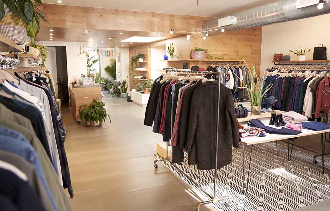Empty retail store with clothes hanging on racks