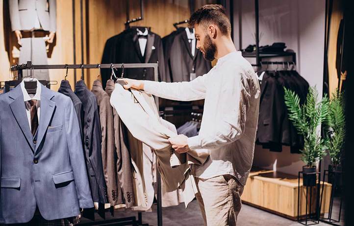 Man at a store looking at a suit.