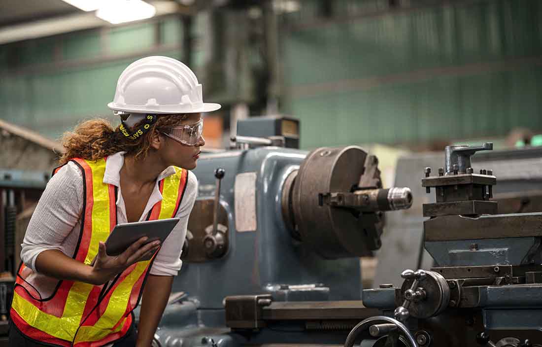 Woman testing equipment in a manufacturing factory.