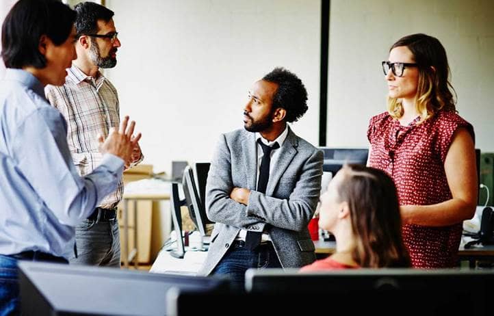 People sitting around a table discussing hedge funds