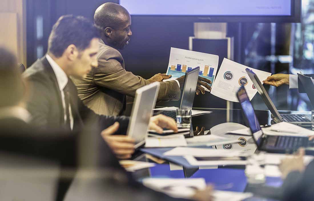 People sitting at a table looking at data