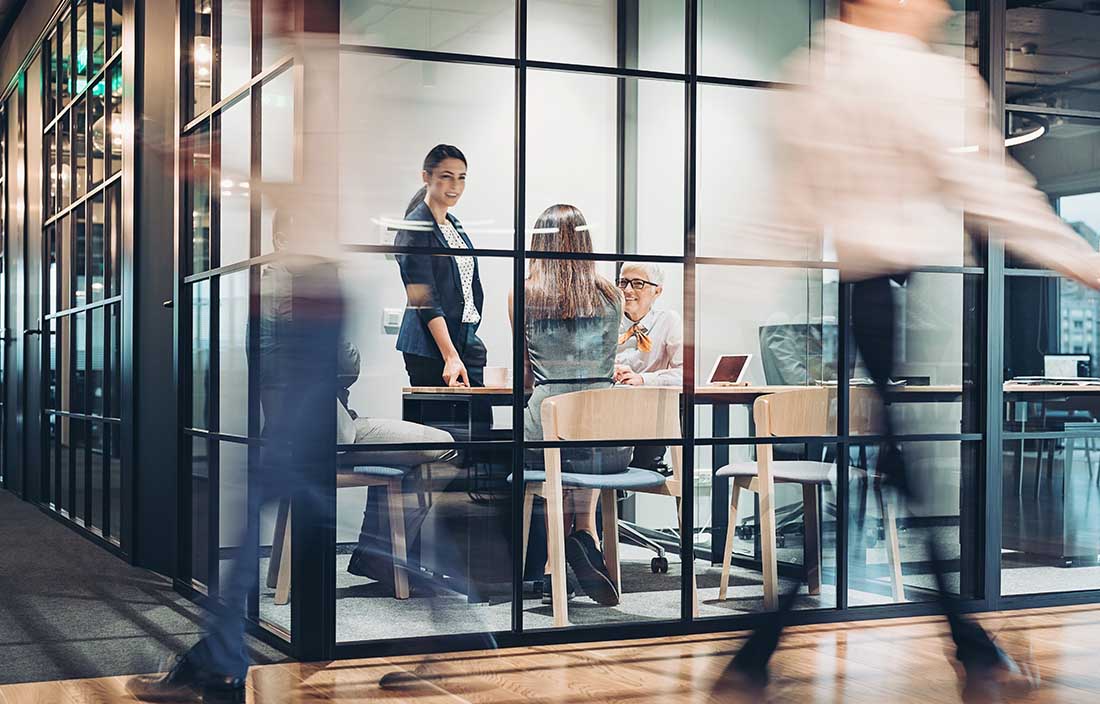 People in a conference room in a busy office