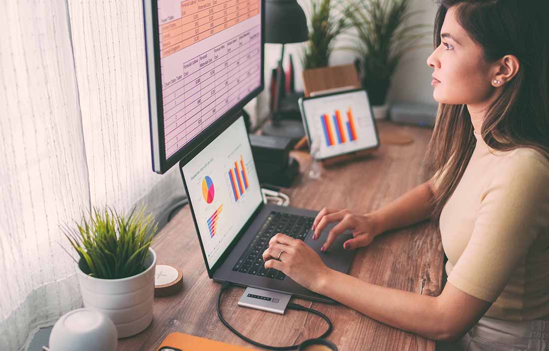 Woman looking at economic data on computer