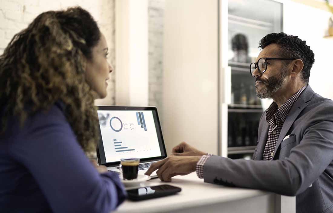 Two people sitting at a computer discussing this years equity rally