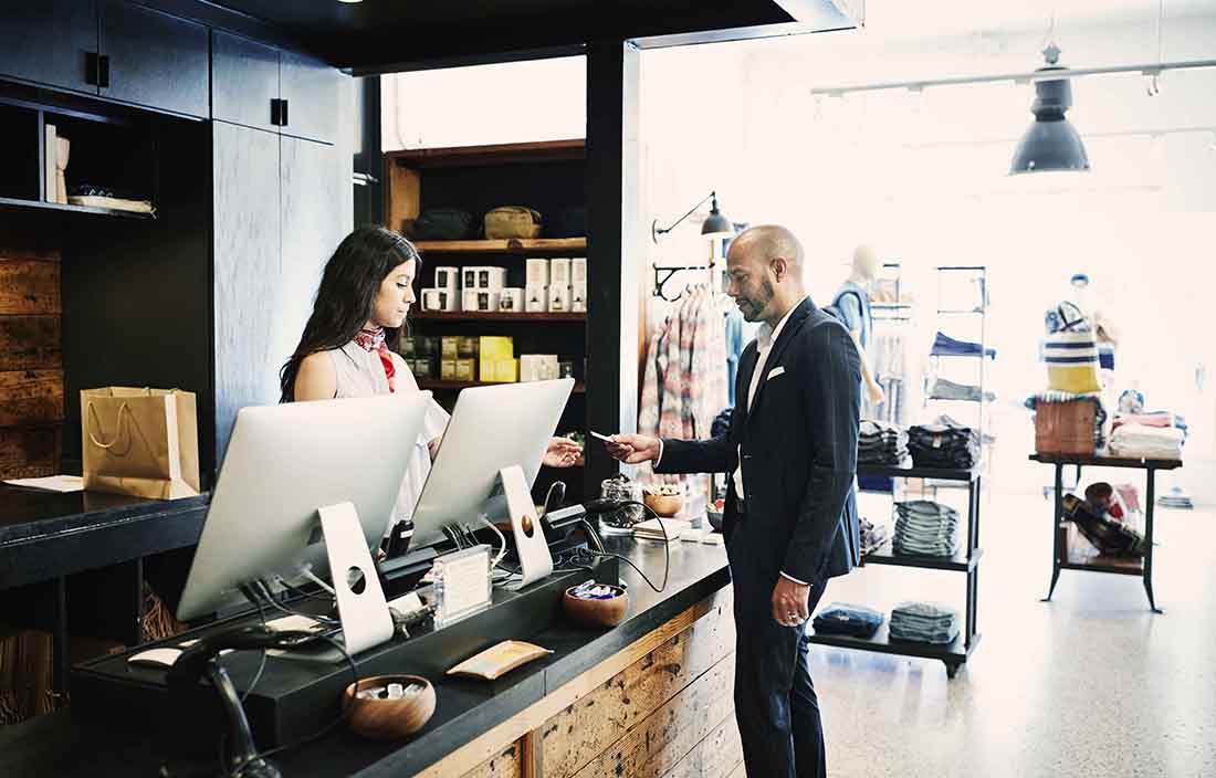 Worker making a sale to a consumer at a retail store