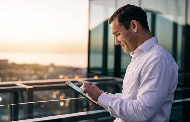 Man looking down at tablet.