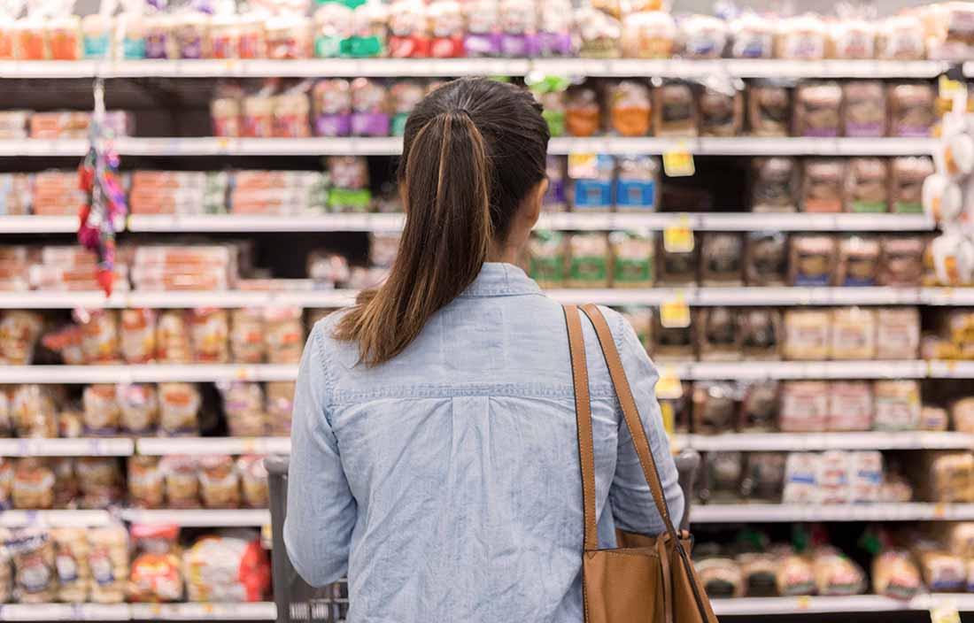 Woman looking at shelf with food at store