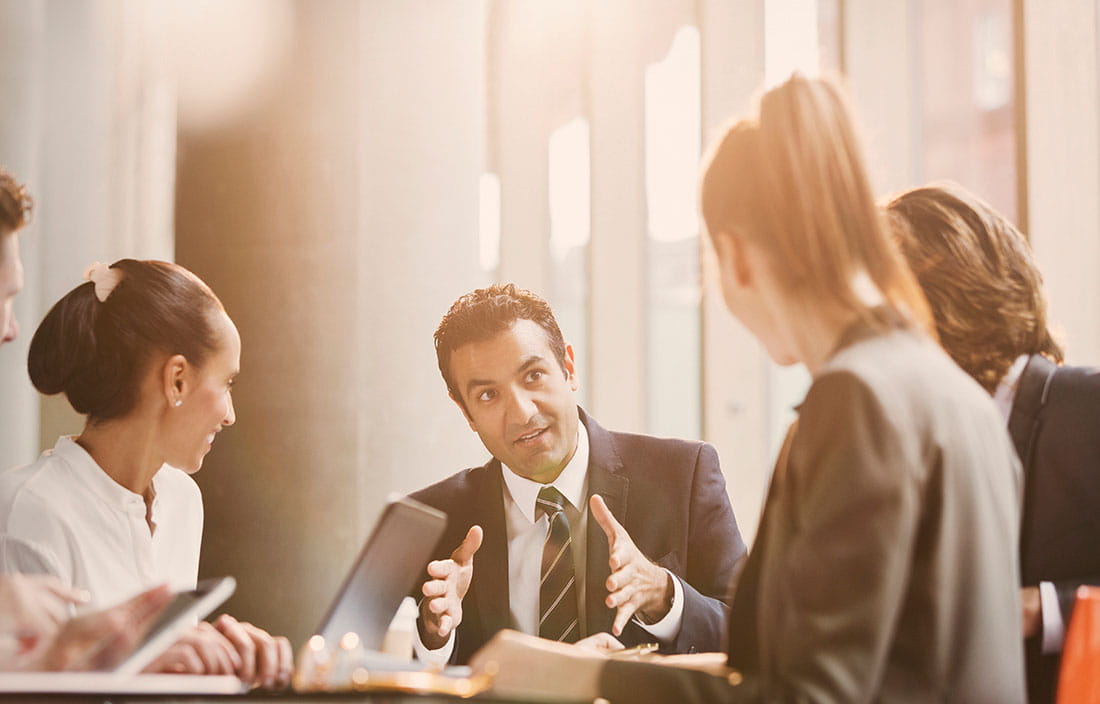 Gentleman speaking with a group in a small business meeting.