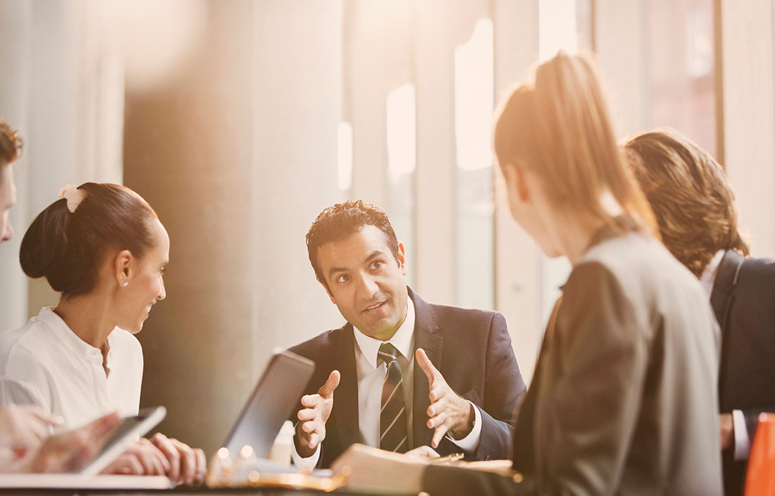Gentleman speaking with a group in a small business meeting.