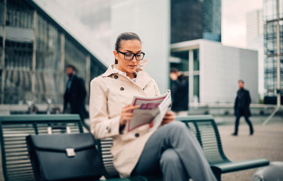 woman reading on bench