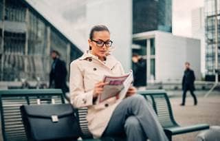 woman reading on bench