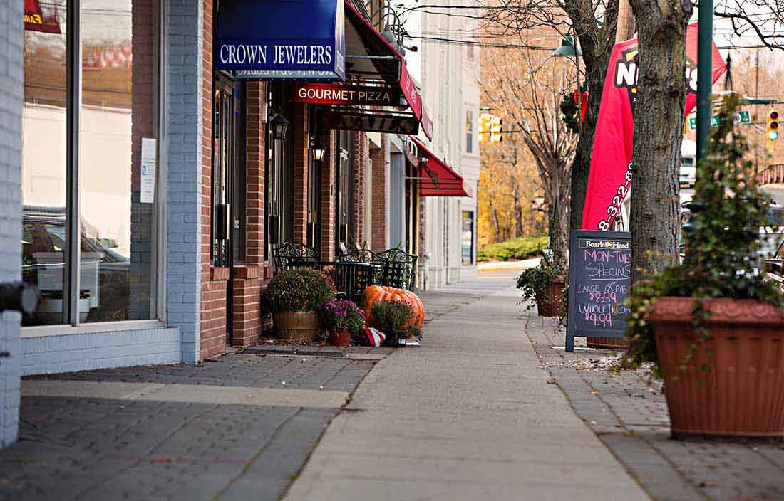 View of shop storefronts alongside a street.
