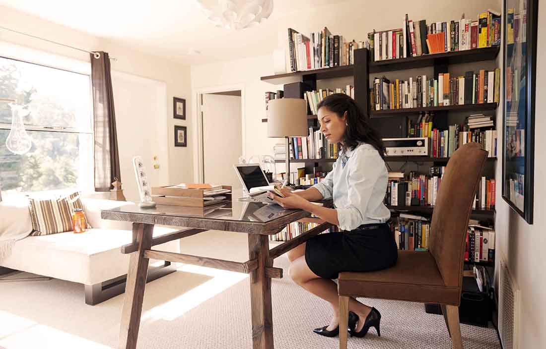 Businesswoman sitting in home office for work.