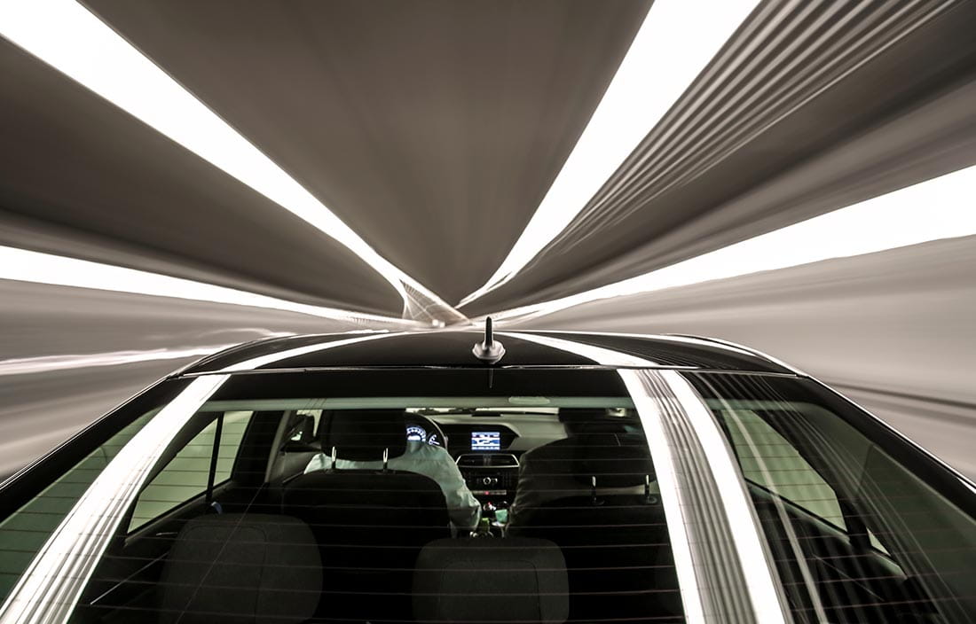 Top view of a futuristic high-end car traveling through a tunnel.