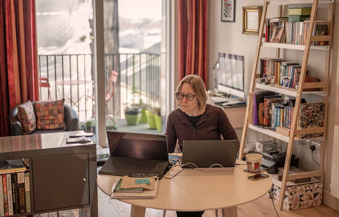 Business professional in a home office working from a laptop computer.